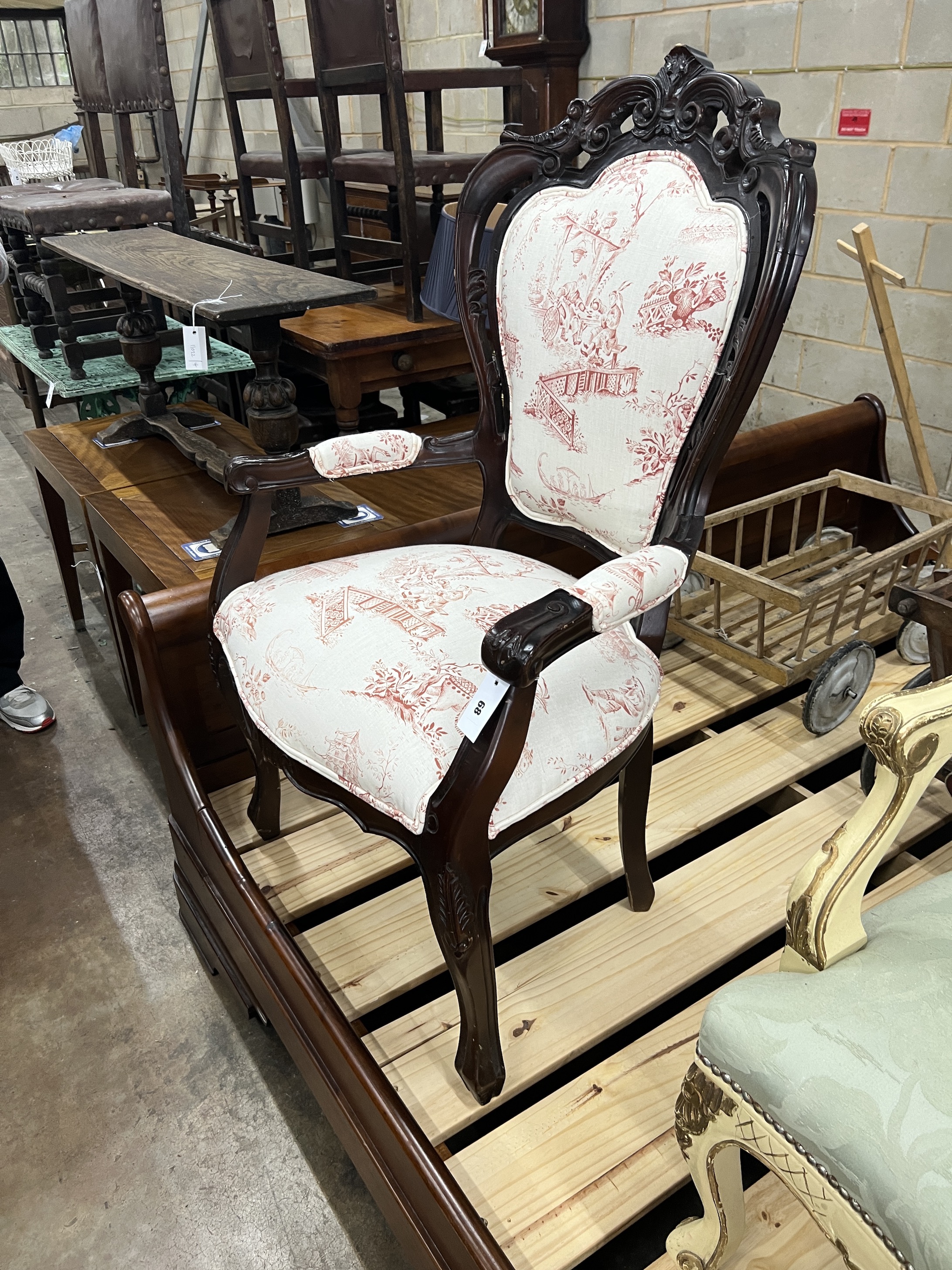 A French carved mahogany upholstered elbow chair, width 69cm, depth 54cm, height 114cm